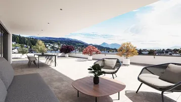 Großzügige Dachterrasse mit modernen Loungemöbeln und weitem Blick auf die umliegende Berglandschaft.