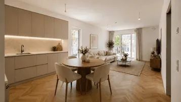 Moderner offener Wohn- und Essbereich mit integrierter Küche und elegantem Fischgrätparkettboden.