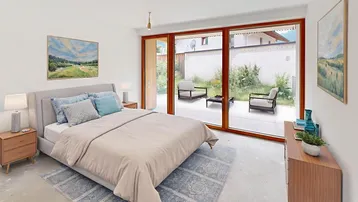 Helles Schlafzimmer mit Zugang zur Terrasse und Blick auf den grünen Außenbereich.
