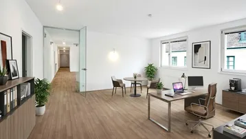 Heller und moderner Bürobereich mit Holzboden, Schreibtisch und Sitzgelegenheiten, ideal für Empfang oder Einzelbüro.