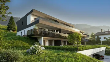Moderne Architektur mit Terrassen und Tiefgaragenzufahrt, eingebettet in eine grüne Hanglage.