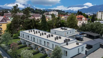 Luftaufnahme einer modernen Wohnanlage mit Reihenhäusern, Gärten, Carports und Gemeinschaftspool.