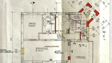 Grundriss des Erdgeschosses mit offener Wohnküche, Zimmer, Bad und Terrasse.