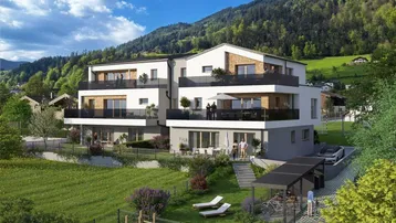Moderne Wohnanlage mit mehreren Balkonen und Terrassen in grüner Berglandschaft.