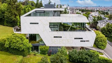 Moderne Villa mit markanter Architektur, großen Glasflächen und Panoramablick über die Stadt.