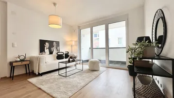 Helles Wohnzimmer mit modernem Design, Holzboden und Zugang zu einem Balkon.
