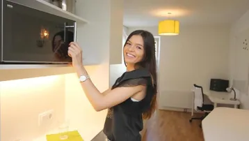 Kleine Küchenzeile mit Mikrowelle, Spüle und Stauraum in einem Studio-Apartment, praktisch und kompakt.