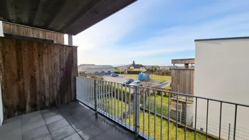 Geräumiger Balkon mit Fliesenboden und weitem Blick über die Umgebung.