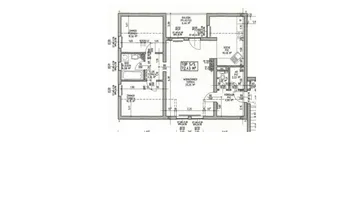 Grundriss einer Wohnung mit Wohnzimmer, Küche, Schlafzimmer, Bad und Balkon.
