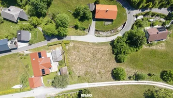 Luftaufnahme mehrerer Häuser und Grundstücke in einer ländlichen Siedlung mit viel Grün.