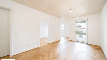Helles, unmöbliertes Zimmer mit Fischgrätparkett und Zugang zu einem Balkon, bereit zur individuellen Gestaltung.