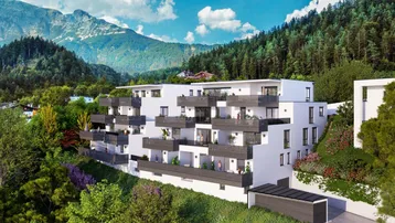 Moderne Wohnanlage in alpiner Landschaft mit Balkonen und Bergblick.
