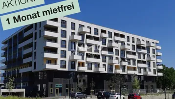 Modernes Mehrfamilienhaus mit zahlreichen Balkonen und einer Aktion für mietfreies Wohnen.