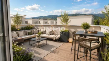 Großzügige Dachterrasse mit modernen Gartenmöbeln und weitem Blick auf die Berge.
