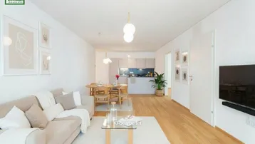 Helles, offenes Wohn-Esszimmer mit moderner Küche, Parkettboden und beiger Einrichtung.