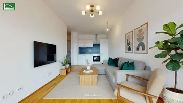 Modernes Wohnzimmer mit offener Küche, Parkettboden und stilvoller Einrichtung.