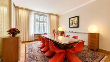 Geräumiger Essbereich mit modernem Esstisch, roten Stühlen und elegantem Parkettboden.