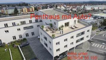 Luftaufnahme eines modernen Gebäudes mit großer, möblierter Dachterrasse und Blick auf die Umgebung.
