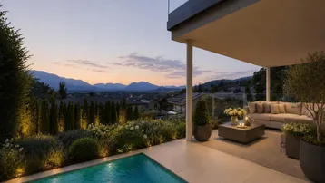 Elegante Terrasse mit Infinity-Pool, gemütlicher Sitzecke und weitem Bergblick bei Sonnenuntergang.