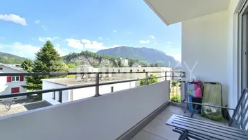 Geräumiger Balkon mit Sitzgelegenheiten und einem weiten Blick auf die umliegende Berglandschaft.