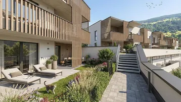 Moderne Wohnanlage mit privaten Gärten, Terrassen und Balkonen, umgeben von grüner Landschaft.