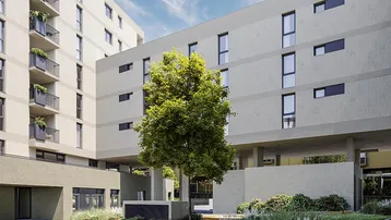 Moderne Architektur des Wohnkomplexes mit begrüntem Innenhof und Bäumen.