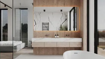 Modernes Badezimmer mit freistehender Badewanne, Doppelwaschbecken und Holzakzenten, offen zum Schlafbereich.