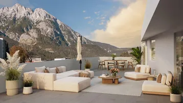 Großzügige Dachterrasse mit bequemen Loungemöbeln und atemberaubendem Bergblick.