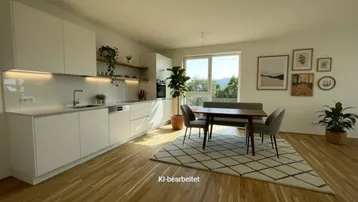 Moderne, helle Küche mit weißen Schränken, Holzboden und Essbereich mit Blick ins Grüne.