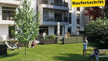 Gemeinschaftlicher Gartenbereich mit Rasenflächen, Bäumen und Sitzgelegenheiten für Bewohner.