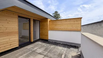 Geräumige Dachterrasse mit Holzverkleidung und Blick auf den Himmel, ideal für Entspannung im Freien.