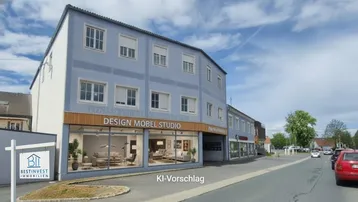 Modernes Geschäftsgebäude mit großen Schaufenstern und blauer Fassade, umgeben von einer Straße und Parkplätzen.
