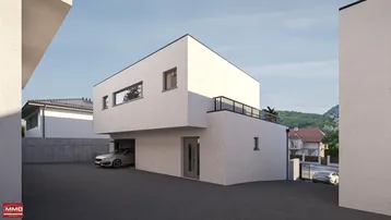 Modernes Haus mit integrierter Garage und Zufahrt, mit Blick auf die umliegende Landschaft.