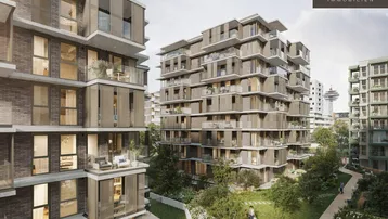 Moderne Wohngebäude mit Balkonen und einem weiten Blick auf die Stadt und einen Turm.