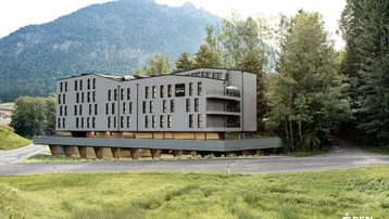 Moderne Architektur eines Gebäudes in alpiner Landschaft mit Bergblick.