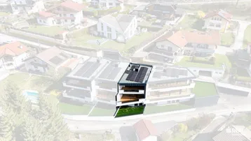 Luftaufnahme eines modernen Reihenhauses mit Photovoltaikanlage auf dem Dach und umliegender Wohnbebauung.