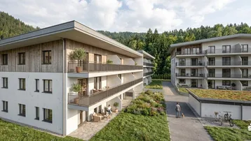 Moderne Wohngebäude mit Holzfassaden und Balkonen, eingebettet in eine grüne Hügellandschaft.