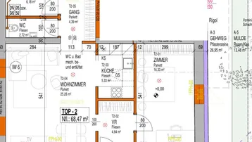 Detaillierter Grundriss der Wohnung TOP-2 mit Wohnzimmer, Küche, Schlafzimmer und zwei Bädern.