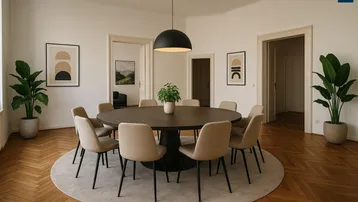 Eleganter Ess- oder Besprechungsraum mit rundem Tisch, bequemen Stühlen und Fischgrätparkettboden.