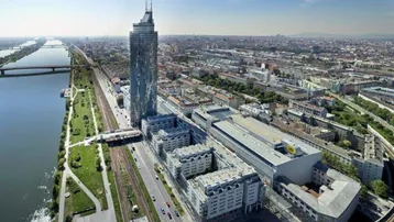 Luftaufnahme einer modernen Stadtlandschaft mit einem hohen Wolkenkratzer und einem Fluss, der sich durch die Stadt schlängelt.