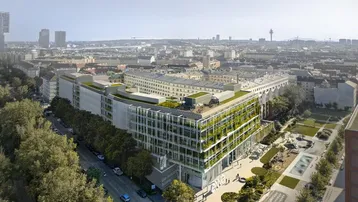 Luftaufnahme eines modernen Gebäudekomplexes mit begrünten Fassaden und Dächern in einer städtischen Umgebung.