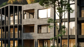 Moderne Architektur mit Holzfassade und großen Fenstern, umgeben von üppiger Natur und Bäumen.