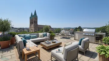 Große möblierte Dachterrasse mit Essbereich, Lounge und Blick auf die Stadtkirche.