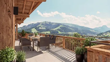 Große Sonnenterrasse mit Esstisch, Pflanzen und atemberaubendem Blick auf die grünen Berge.