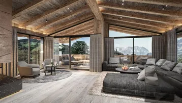 Gemütliches Wohnzimmer in einem modernen Chalet mit Holzbalken, großen Fenstern und Bergblick.