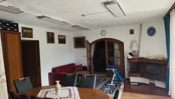 Wohnzimmer mit Kamin, traditionellen Möbeln und Teppichen, strahlt eine gemütliche Atmosphäre aus.