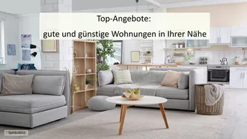Heller offener Wohnbereich mit bequemen Sofas, einem Couchtisch und einer modernen weißen Küche im Hintergrund.