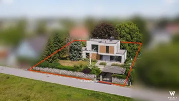 Luftaufnahme eines modern gestalteten Hauses mit Garten und Grundstücksgrenze, KI-bearbeitet.