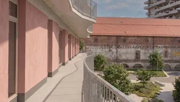 Langer, geschwungener Balkon mit Metallgeländer und Blick auf die umliegende Bebauung und Grünflächen.