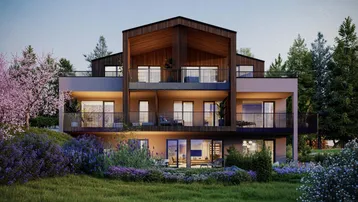 Moderne Wohnanlage mit Holzfassade und mehreren Balkonen, umgeben von grüner Natur.